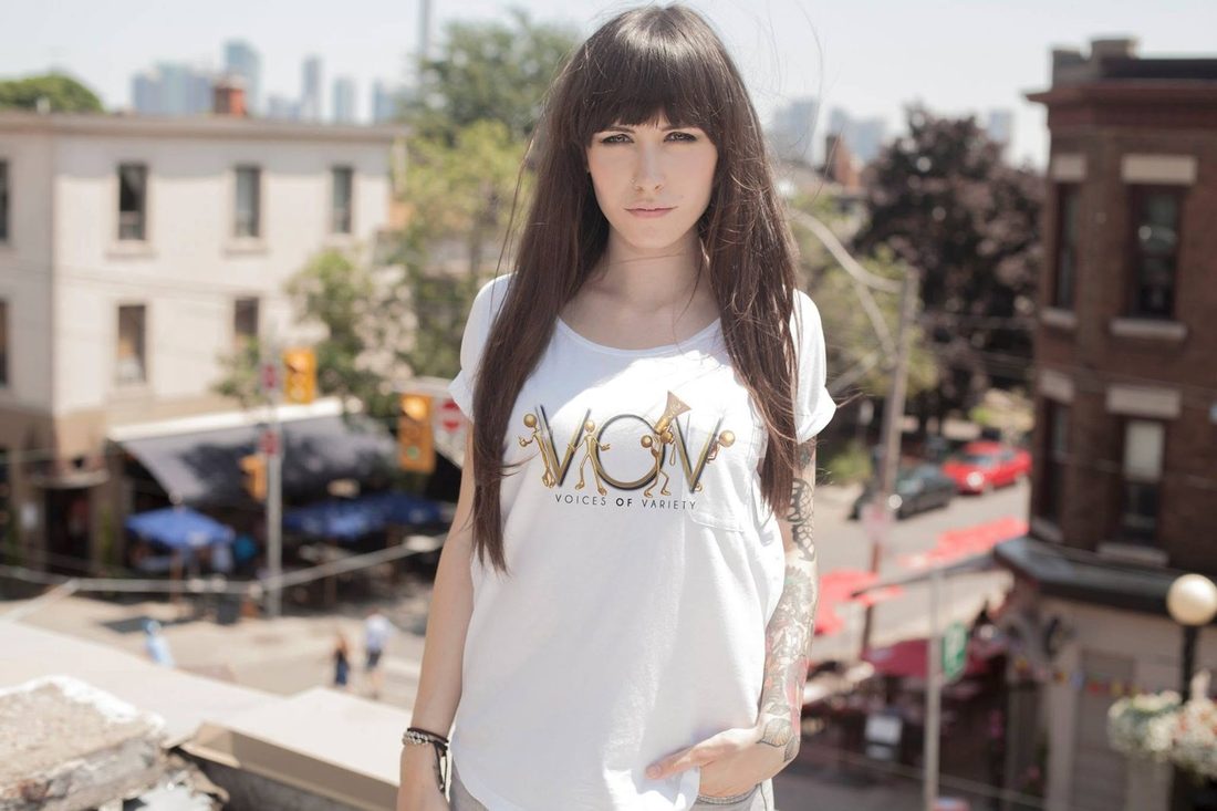 Model on a rooftop in the white V.O.V tee