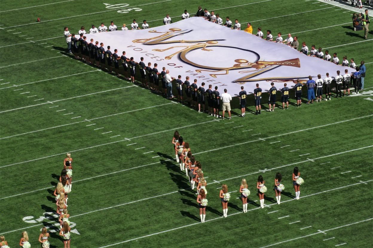 The V.O.V flag unfurled across a stadium field