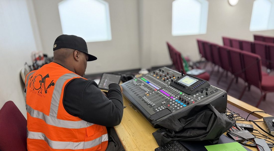 A V.O.V engineer running the mixing board