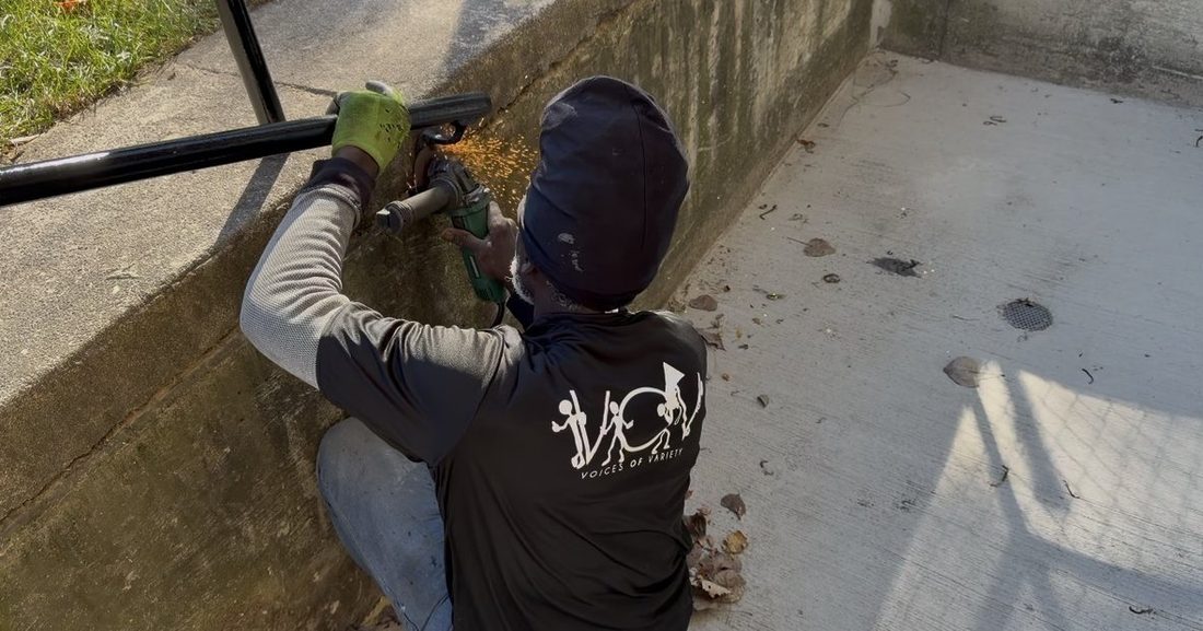 A V.O.V member grinding a handrail with sparks flying