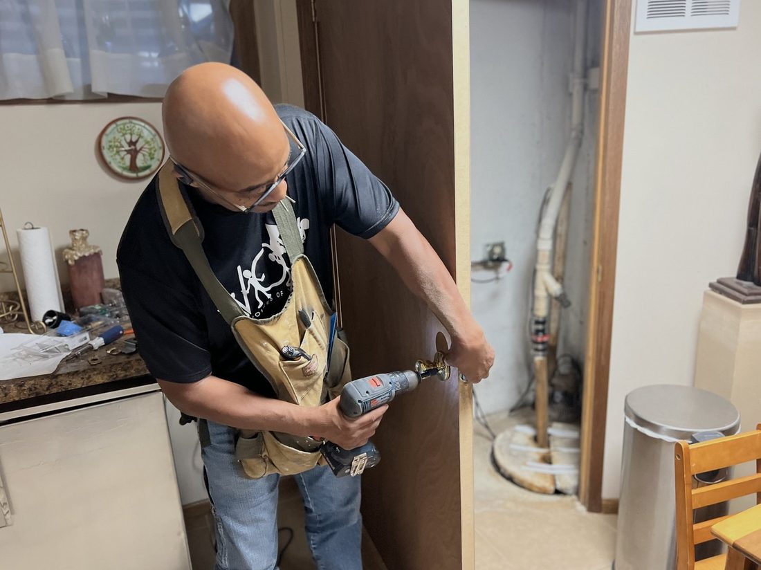 A V.O.V member drilling a door hinge