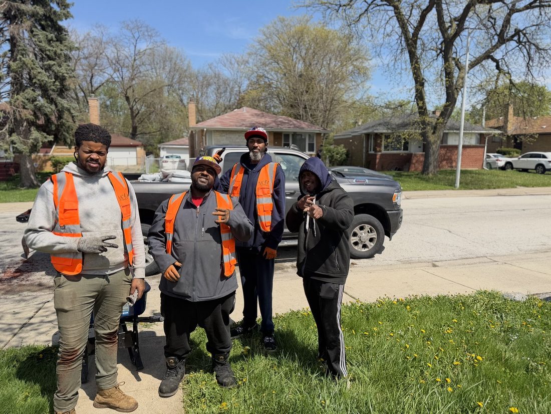Four V.O.V crew members in safety vests by the truck