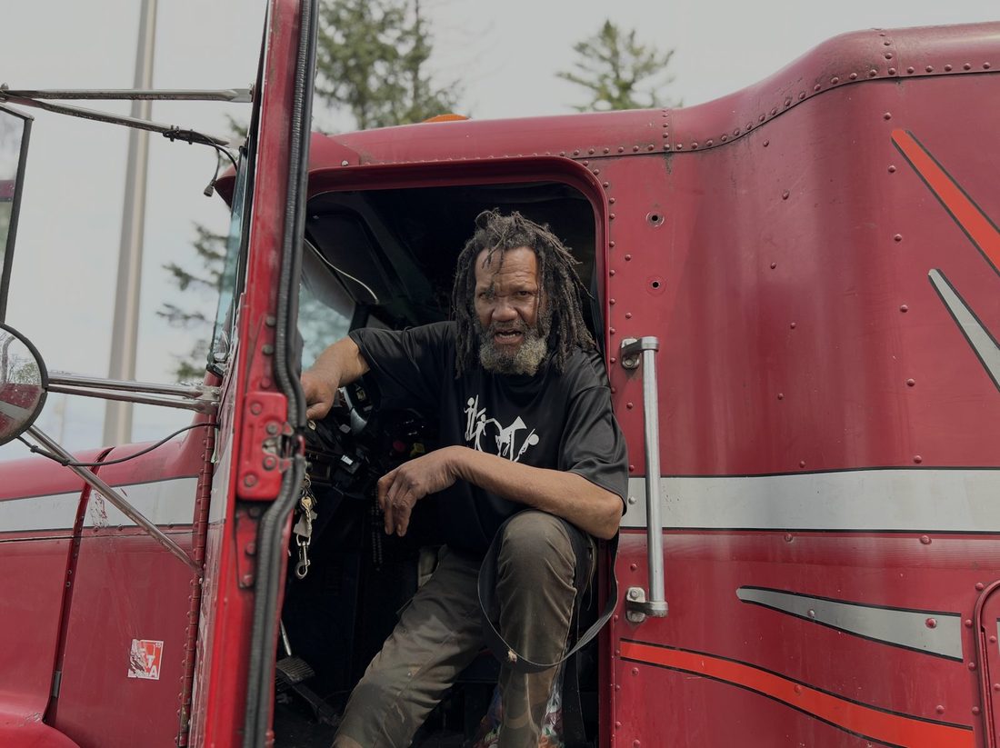 A V.O.V member in the cab of his red semi truck