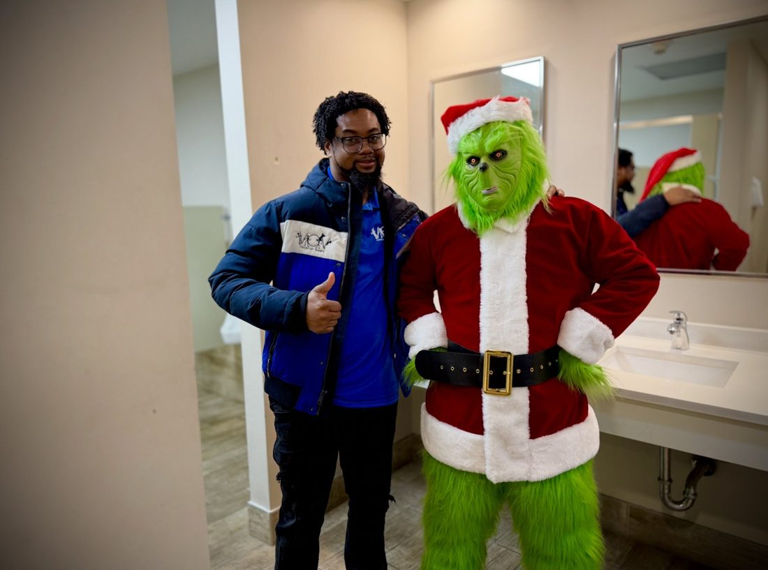 A V.O.V member with the Grinch at the holiday giveaway