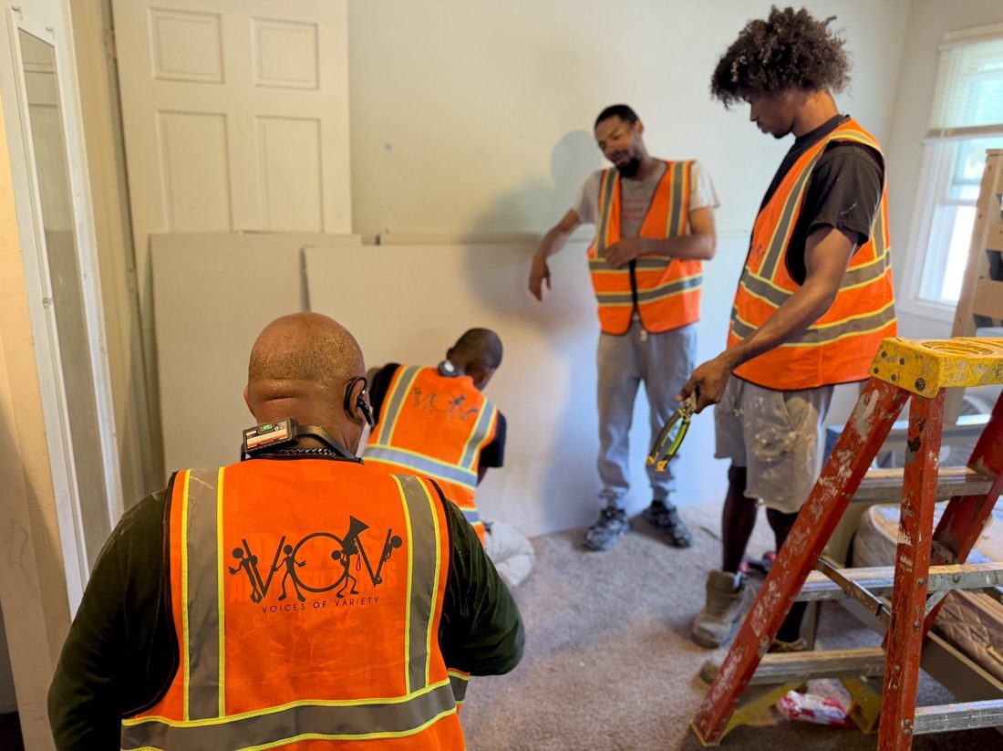 The V.O.V rebuild crew working a room together