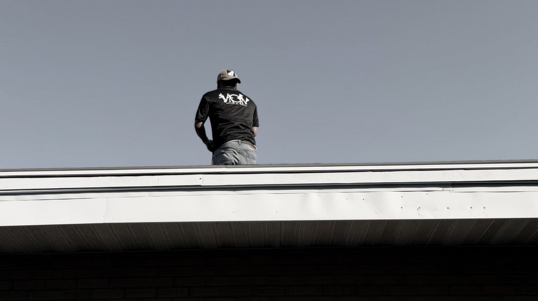 A V.O.V crew member standing tall on a rooftop