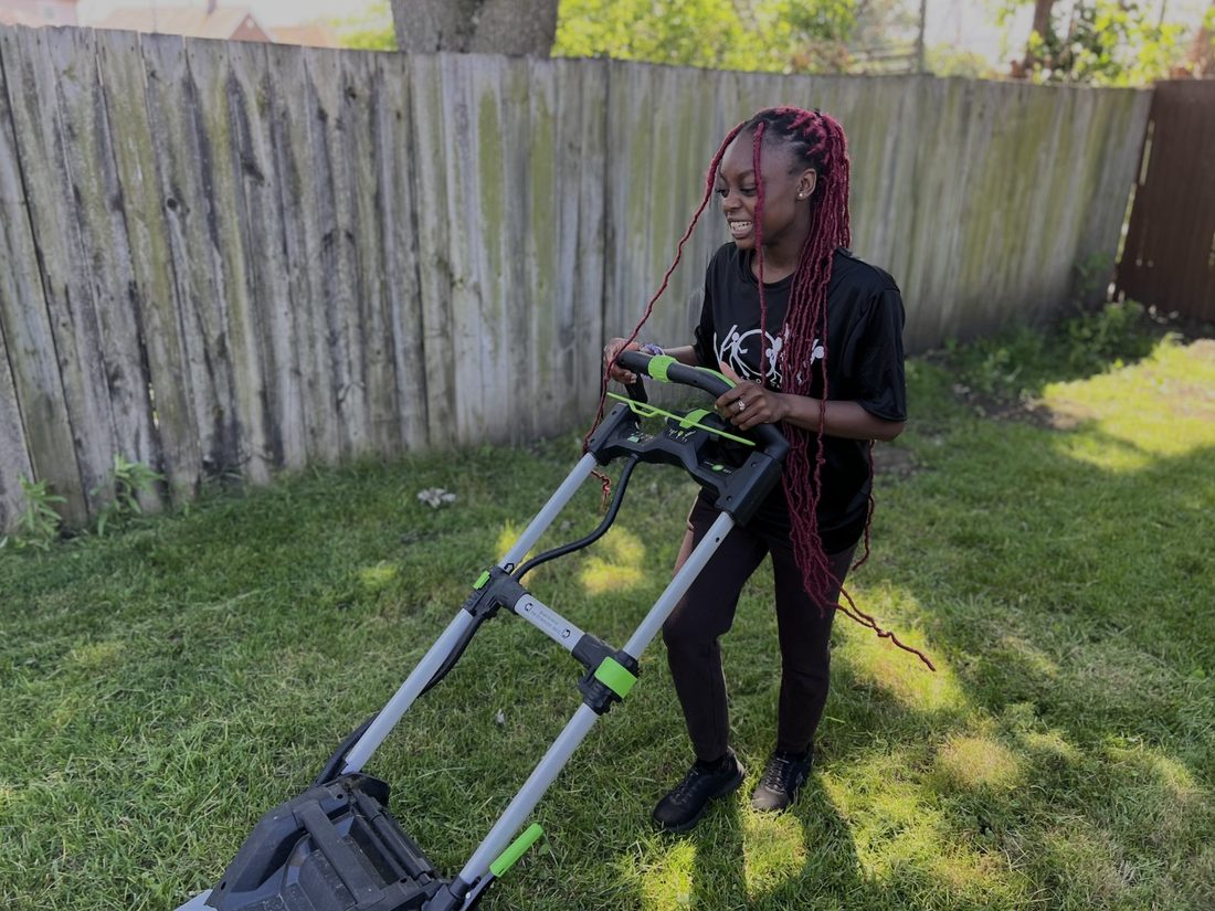 A V.O.V member mowing a neighbor&rsquo;s lawn with a smile